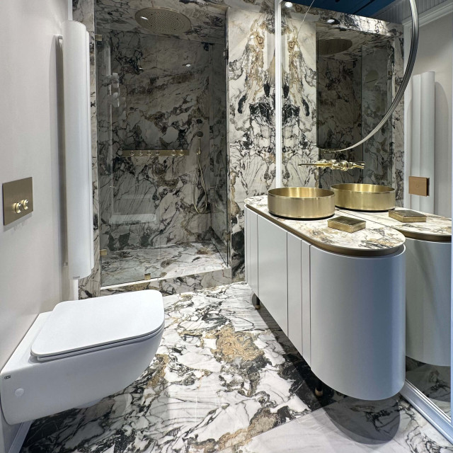 Sink with cabinet, shower cabin and toilet in the salon of luxury bathroom equipment EURODOM TILE & STYLE