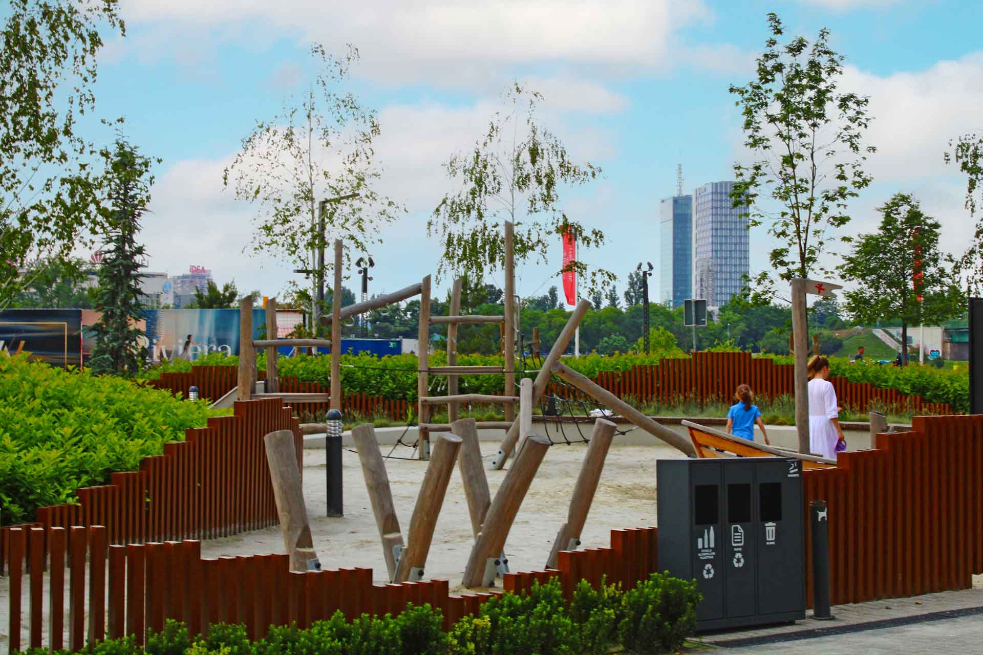 A sand park in front of the BW Terraces building where all the equipment is made of wood.