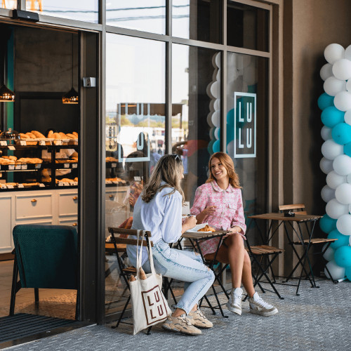 Two girls are talking while having delicious pastries for breakfast at LULU bakery